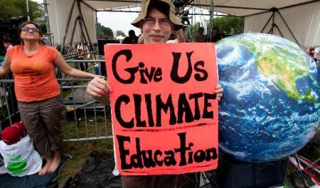 A&nbsp;man&nbsp;holds&nbsp;a&nbsp;cardboard&nbsp;written&nbsp;with&nbsp;Give&nbsp;Us&nbsp;Climate&nbsp;Education&nbsp;at&nbsp;a&nbsp;concert&nbsp;named&nbsp;Climate&nbsp;Rally&nbsp;at&nbsp;the&nbsp;National&nbsp;Mall&nbsp;in&nbsp;Washington&nbsp;D.C,&nbsp;capital&nbsp;of&nbsp;the&nbsp;United&nbsp;States,&nbsp;April&nbsp;25,&nbsp;2010.&nbsp;The&nbsp;Climate&nbsp;Rally&nbsp;was&nbsp;held&nbsp;Sunday&nbsp;to&nbsp;honor&nbsp;the&nbsp;Earth&nbsp;Day&nbsp;that&nbsp;falls&nbsp;on&nbsp;April&nbsp;22&nbsp;and&nbsp;call&nbsp;for&nbsp;fighting&nbsp;against&nbsp;climate&nbsp;change.&nbsp;(Xinhua/Zhu&nbsp;Wei)