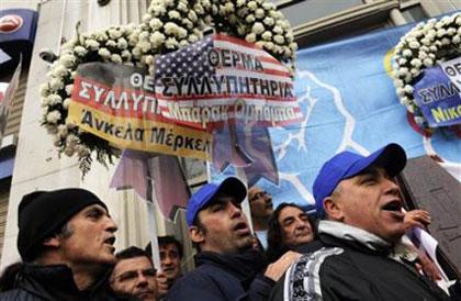 Members&nbsp;of&nbsp;Greece's&nbsp;main&nbsp;GSEE&nbsp;trade&nbsp;union&nbsp;hold&nbsp;a&nbsp;mock&nbsp;funeral&nbsp;with&nbsp;a&nbsp;coffin&nbsp;standing&nbsp;for&nbsp;the&nbsp;Greek&nbsp;economy&nbsp;surrounded&nbsp;by&nbsp;wreaths&nbsp;from&nbsp;Greece's&nbsp;international&nbsp;partners&nbsp;in&nbsp;central&nbsp;Athens&nbsp;on&nbsp;Wednesday,&nbsp;March&nbsp;10,&nbsp;2010.&nbsp;(AP&nbsp;Photo/Marita&nbsp;Pappa)